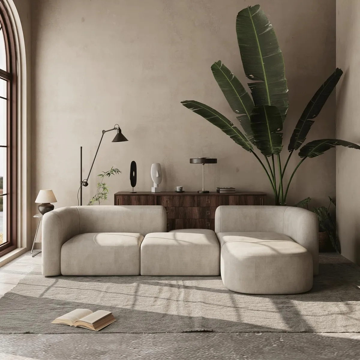 This living room sofa showcases the beauty of curved design. Its rounded edges and seamless upholstery add a sophisticated touch, while the neutral palette keeps it versatile. Pairing it with oversized plants or minimalist decor enhances the organic feel. 