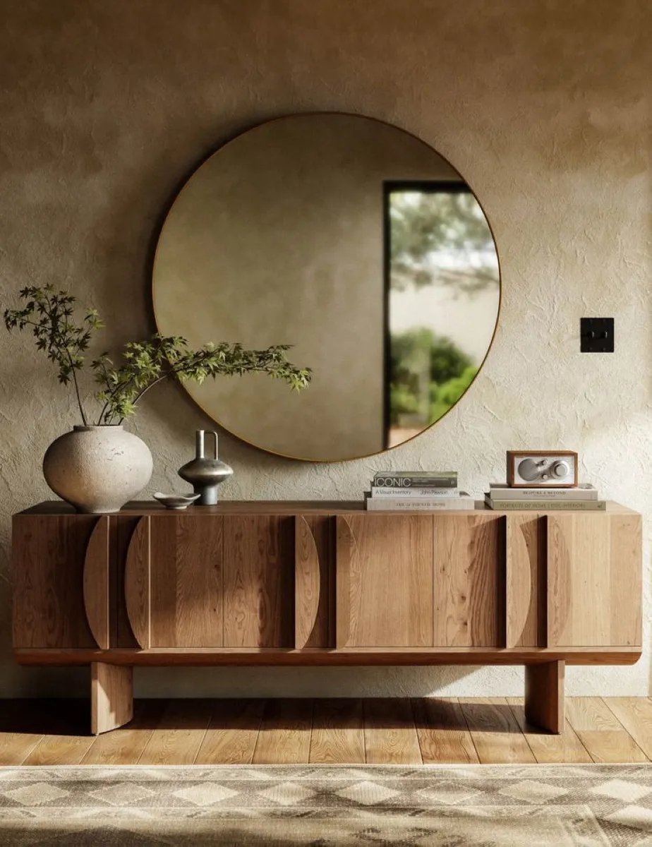 This console table blends curved artistry with functionality. Its rounded details soften the room while maintaining practicality. Adding a circular mirror above it amplifies the theme, creating a cohesive and visually balanced look. 