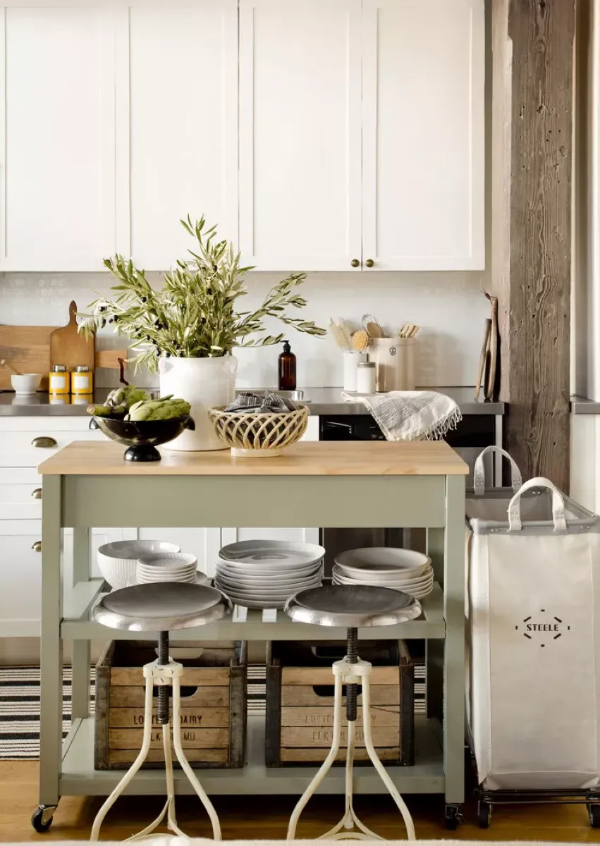 Sleek Minimalism with Marble and Neutral Tones This marble kitchen island combines clean lines with neutral tones for a minimalist aesthetic. The sturdy wooden stools add a touch of warmth to the design. For an affordable alternative, opt for peel-and-stick marble vinyl for countertops and repurpose chairs with a fresh coat of paint.