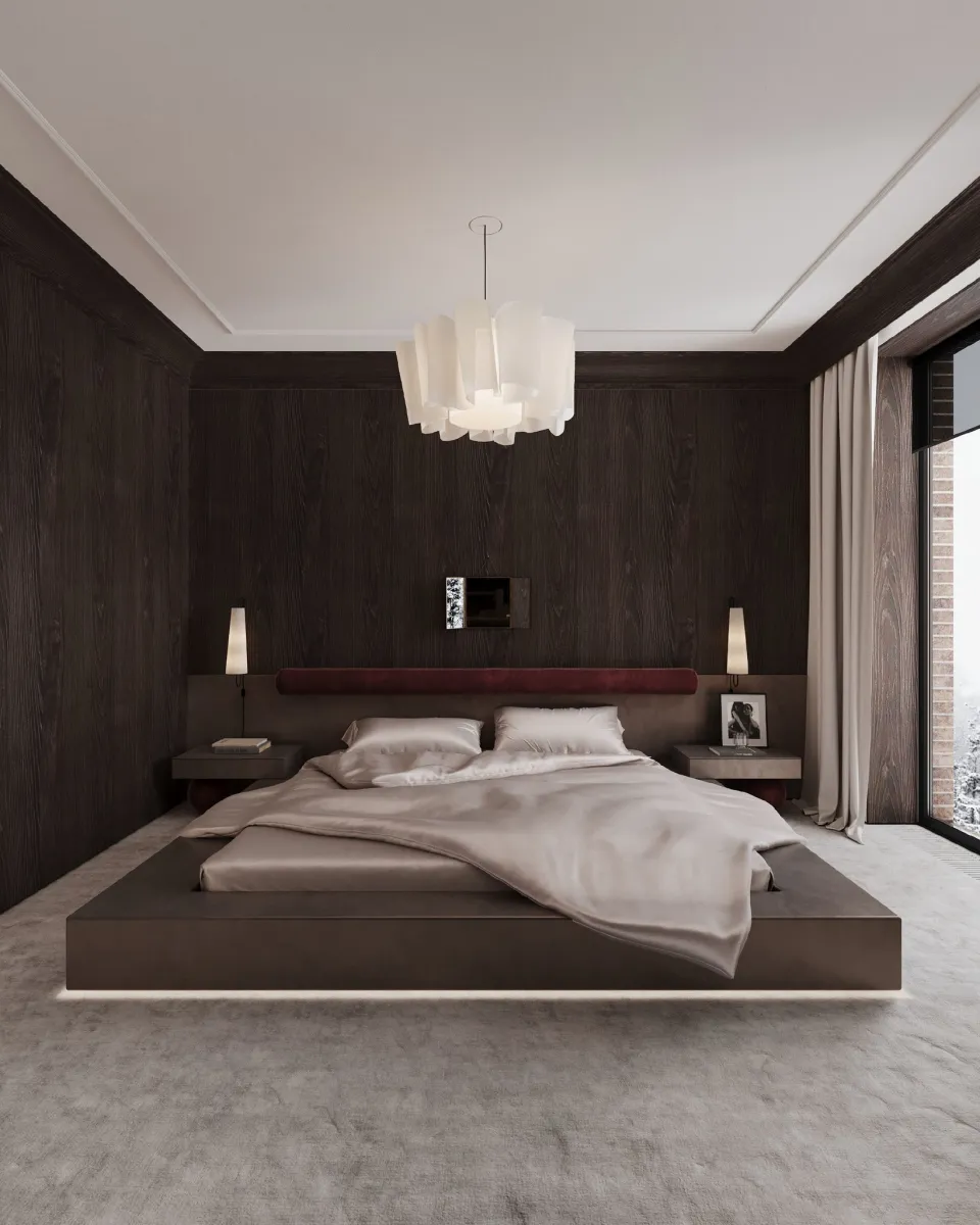 Dark cozy bedroom with LED-lit platform bed and textured walls. Dark wood-paneled walls might sound risky, but here, they’re pure magic. The LED-lit platform bed seems to float, and the layered chandelier softens the moodiness. 