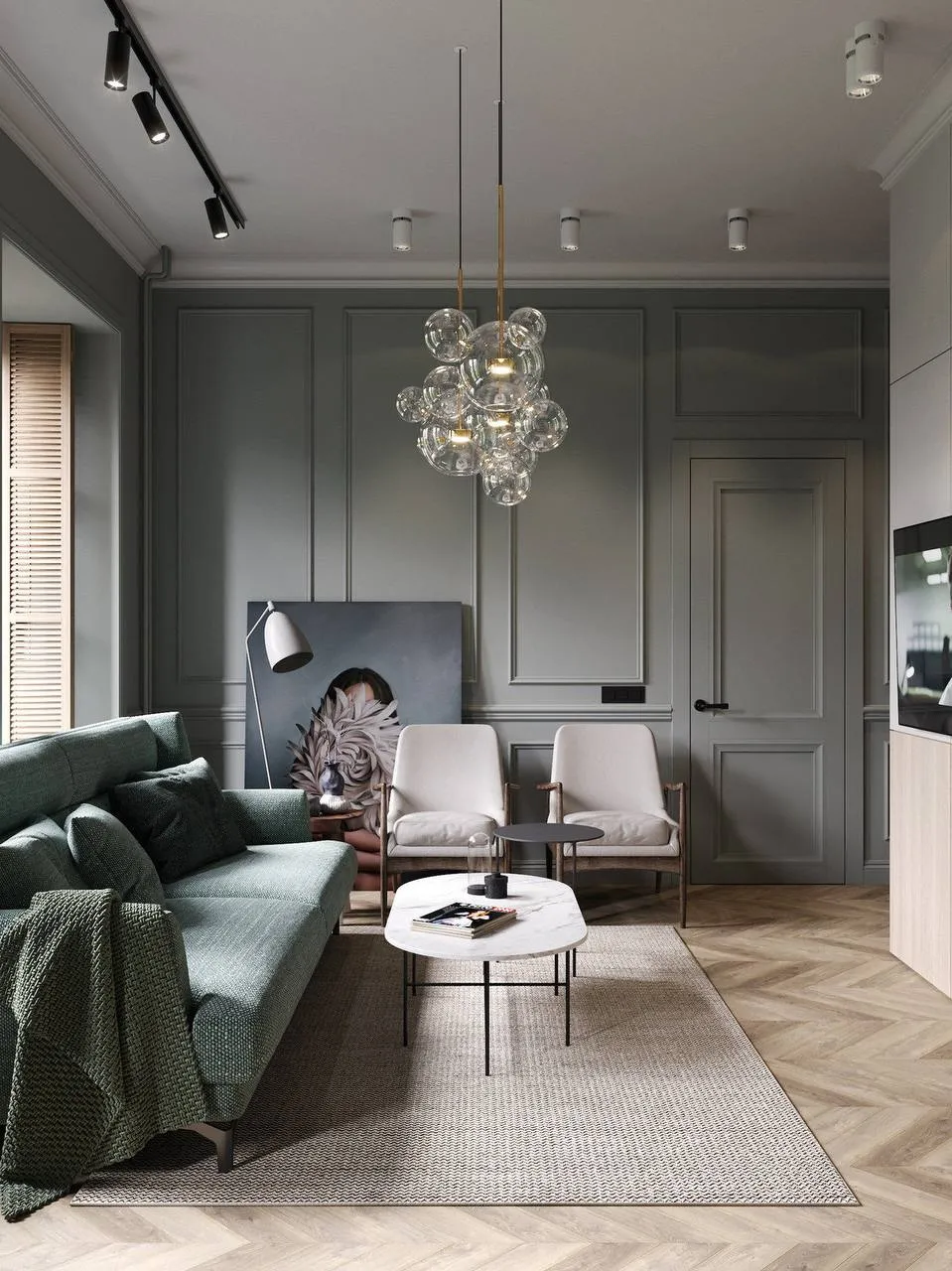 Chic seating area with plush green sofa, beige armchairs, low-profile coffee table, beige rug, and pendant lighting creating a luxurious yet cozy space.