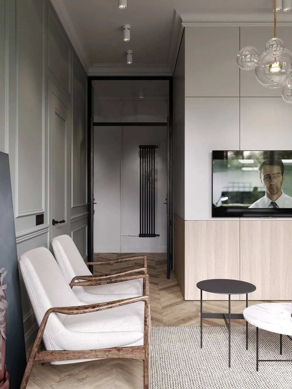 Stylish TV area with minimalist armchairs, light wood TV console, muted green and beige tones, recessed lighting, and pendant light creating a functional, chic space.