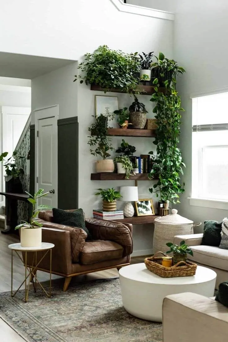 A stylish living room with floating shelves showcasing vibrant plants and books. The cascading vines create a lively atmosphere, complementing the earthy tones of the decor.