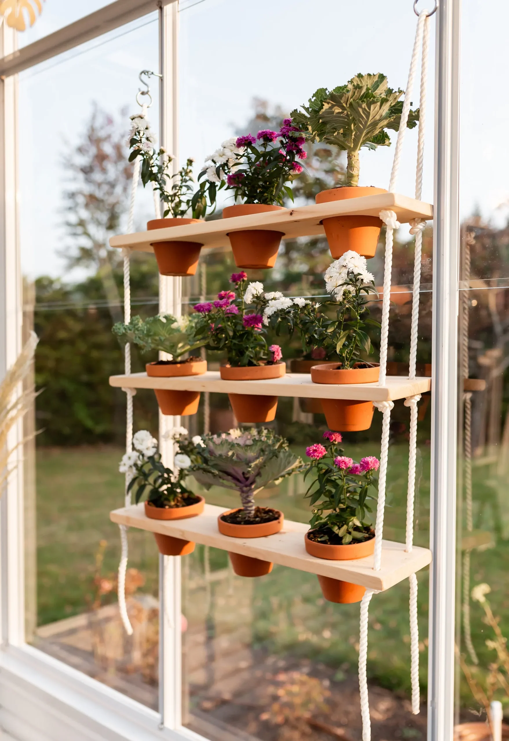 Rope Hanging Plant Shelf
Suspended by ropes, this creative plant shelf design allows potted flowers and herbs to bask in sunlight. Ideal for windows, it merges rustic charm with a contemporary touch.

