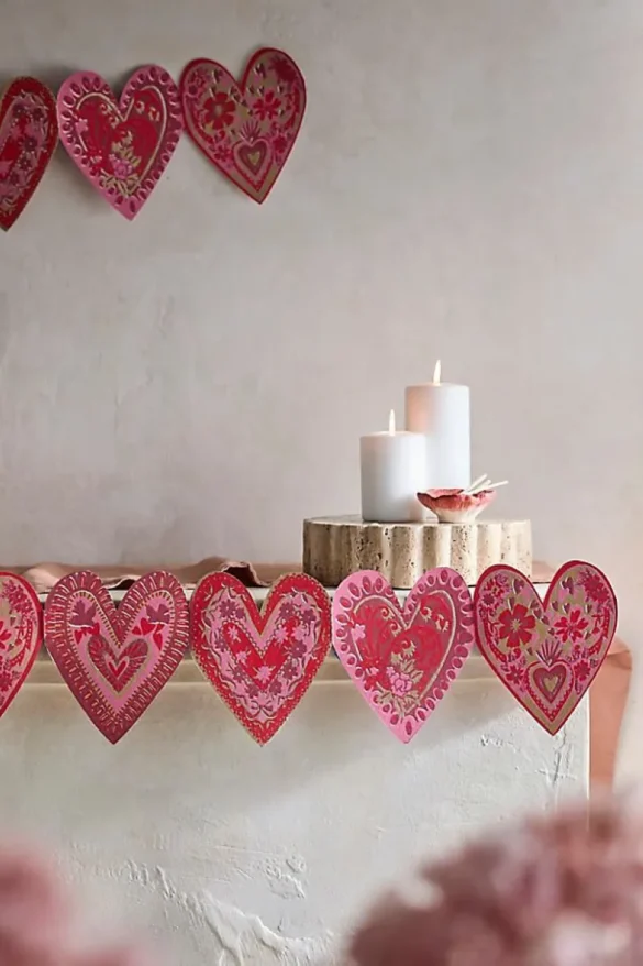 Garlands are not just for mantels—they work beautifully on tablescapes, around mirrors, or even draped across headboards. A heart garland paired with fresh flowers can transform any space into a Valentine’s wonderland. Add glitter accents for a playful touch or stick to neutral tones for a subtler look.