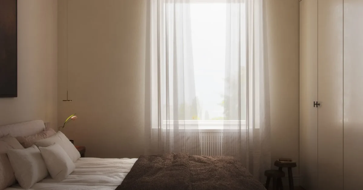 Modern bedroom decor with soft neutrals, warm lighting, and a cozy aesthetic. Minimalist interior with a plush bed, sheer curtains, and natural textures. #MinimalistBedroom #ModernDecor