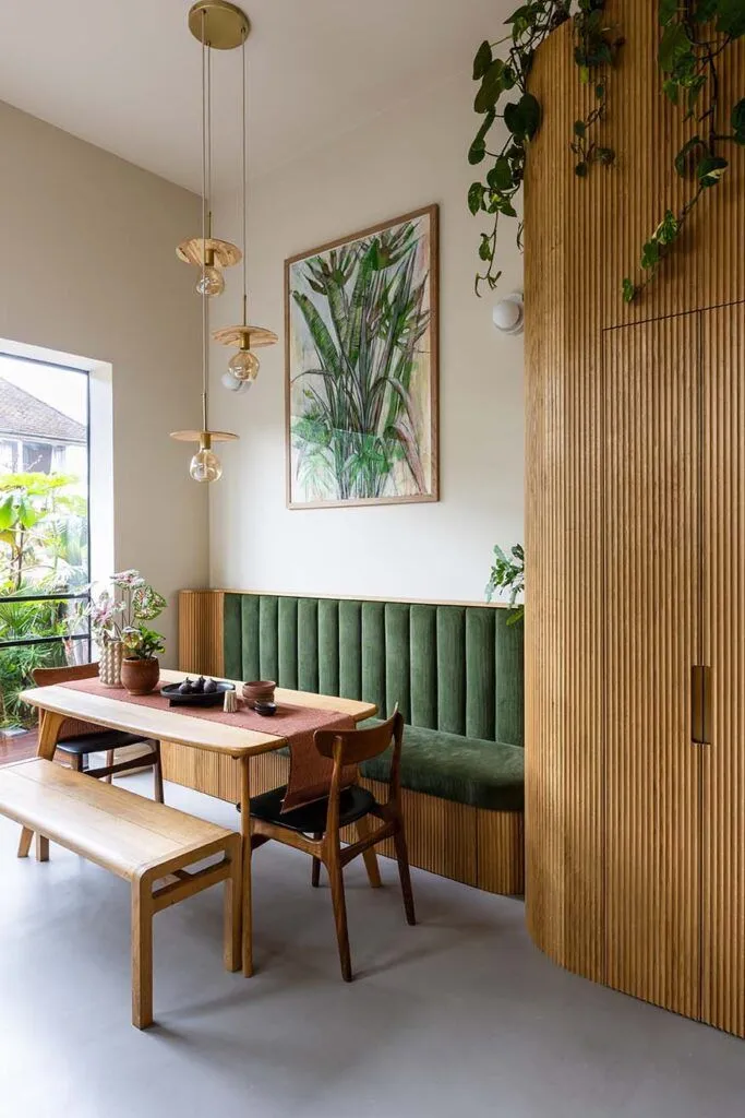 Bright and airy corner dining nook with warm wood tones, natural light, and soft cushions—perfect for a cozy and stylish small space.