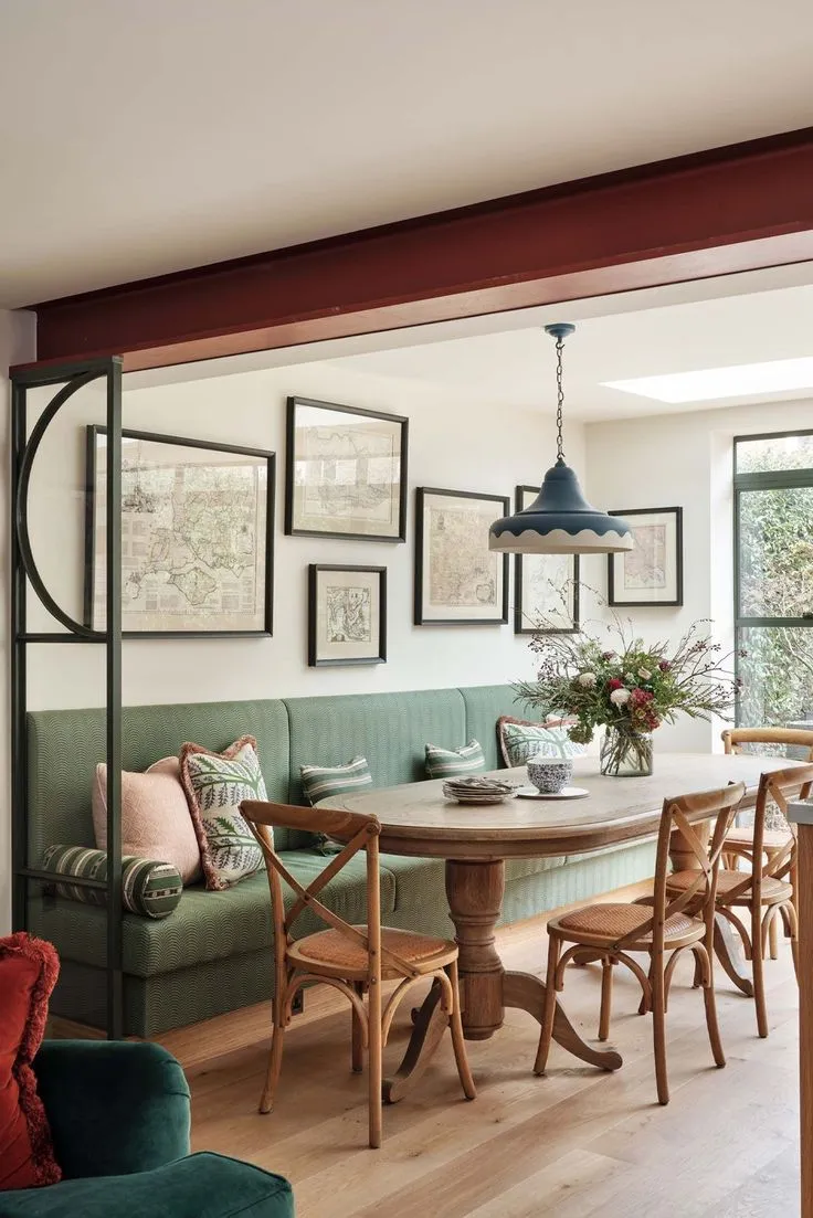 Luxury corner dining nook with elegant upholstered bench seating, deep tones, and statement lighting for a sophisticated dining space.