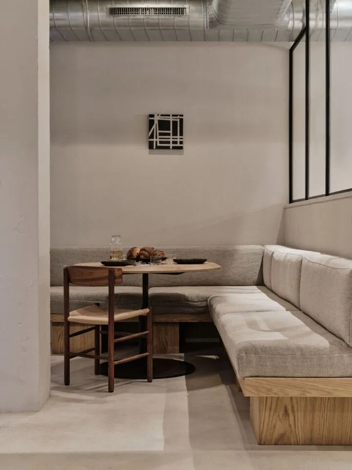 Scandinavian-inspired corner dining nook with natural wood, clean lines, and a warm, inviting atmosphere for intimate dining moments