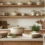 Discover beautiful ceramic cookware and bakeware to elevate your kitchen styling. Featuring a cream Dutch oven, rectangular baking dishes, and fresh bread on a modern stone countertop