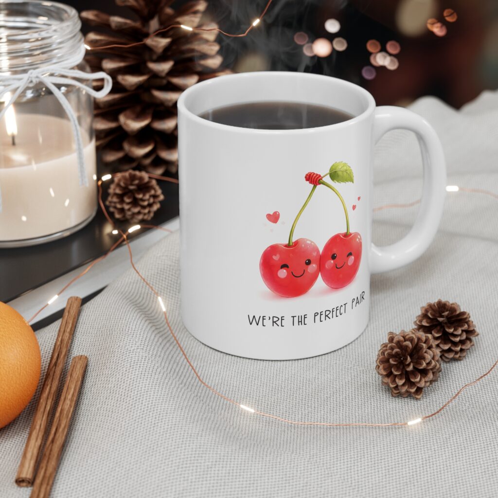 A delightful coffee mug featuring two smiling cherries and the phrase We’re the Perfect Pair. This 11 oz white ceramic mug is microwave‑safe and dishwasher‑safe, making it perfect for Valentine’s Day gifting or everyday drinkware.