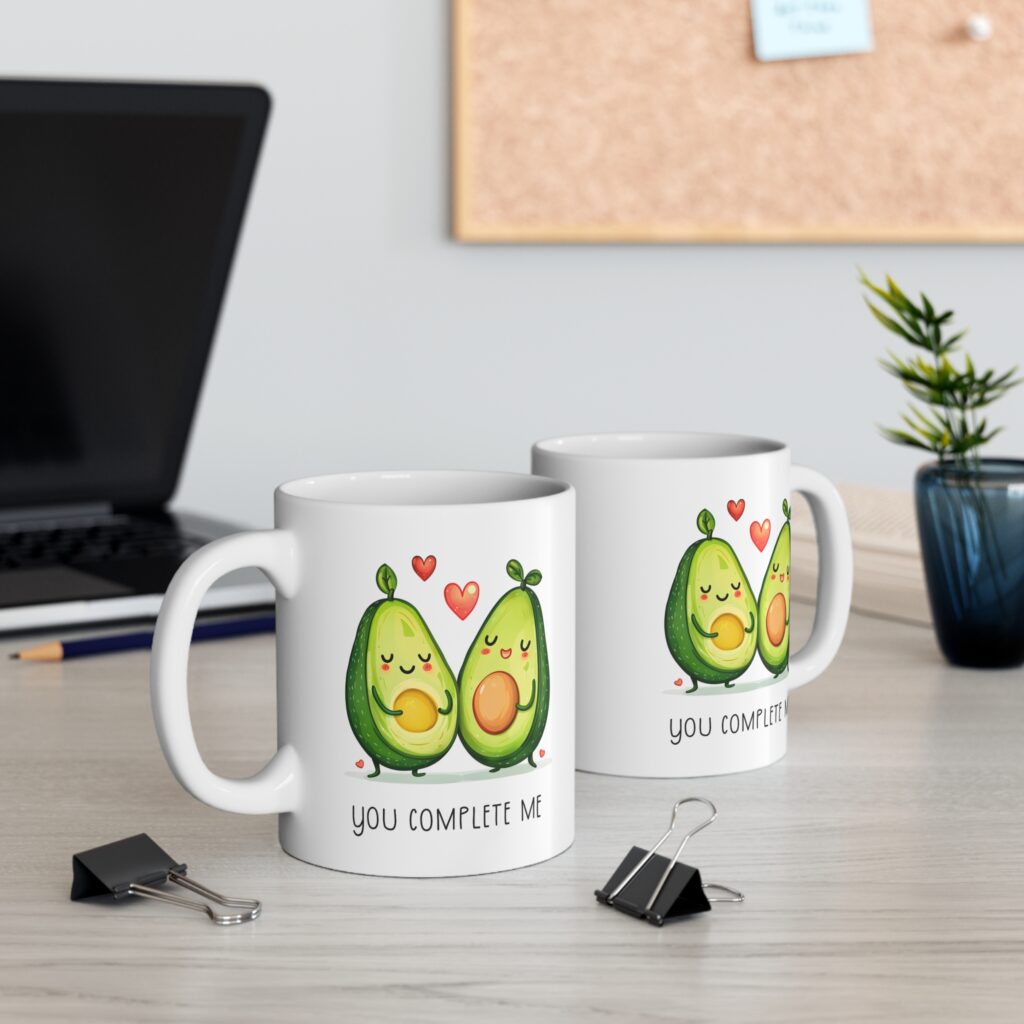 A playful and heartwarming coffee mug featuring cheerful avocado halves and the message You Complete Me. This 11 oz white ceramic mug is microwave‑safe, dishwasher‑safe, and ideal for Valentine’s Day gifting or everyday use.
