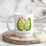 A playful and heartwarming coffee mug featuring cheerful avocado halves and the message You Complete Me. This 11 oz white ceramic mug is microwave‑safe, dishwasher‑safe, and ideal for Valentine’s Day gifting or everyday use.