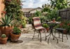 Mexican Backyard Ideas That Actually Work for a Regular American Yard (Under $200) Mexican backyard ideas with terracotta pots, wrought iron furniture, and a woven blanket on a regular American patio.