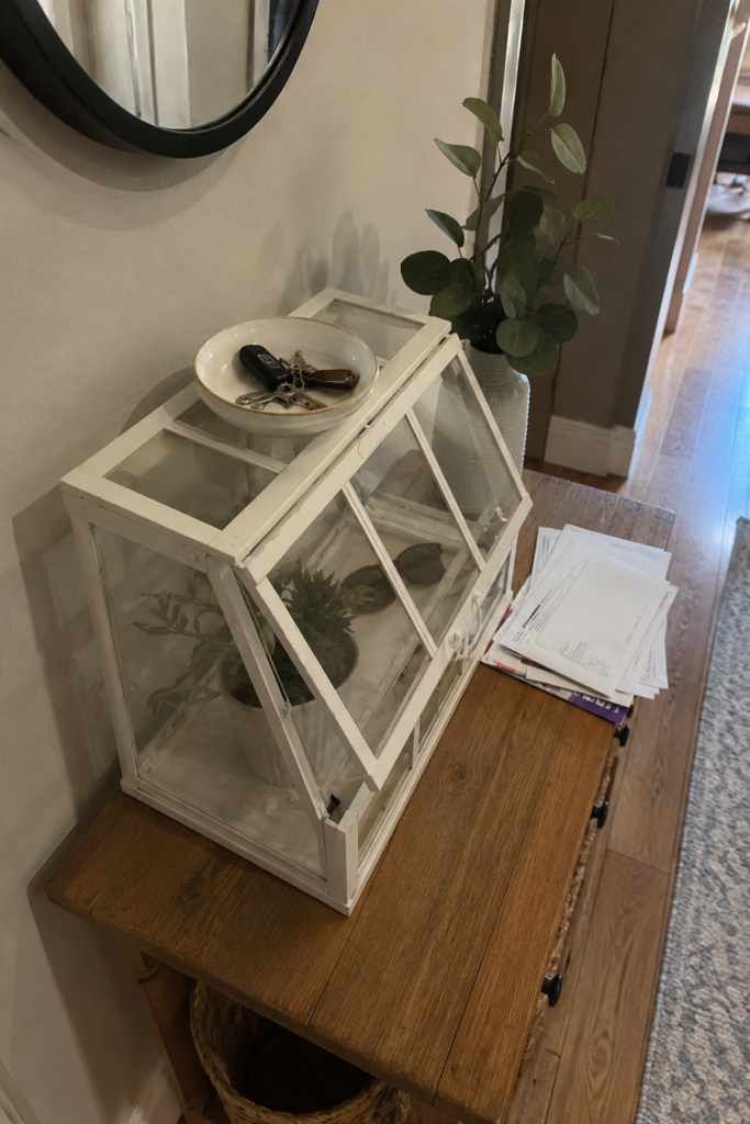 Overhead angled shot of IKEA ÅKERBÄR greenhouse entryway organizer with keys and mail