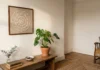 The Doily Decor Trend Is Back, and It’s Not What Your Grandma Did Vintage cream lace doily in a simple wood frame, propped against a wall before hanging