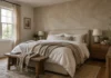 How to Limewash Painted Walls: A Product-First Guide Bedroom with soft greige limewash walls, a linen upholstered bed, oak nightstand and a ceramic lamp in warm afternoon light.