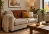Fall Throw Blanket Layering on a Small Sofa Without the Pile Small two-seat sofa in oatmeal linen layered with a cream knit throw, rust wool throw and mustard pillow in a fall living room