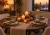How to Set a Thanksgiving Table When the Table Is Small Small dining table set for Thanksgiving with four place settings and a low centerpiece in warm evening light